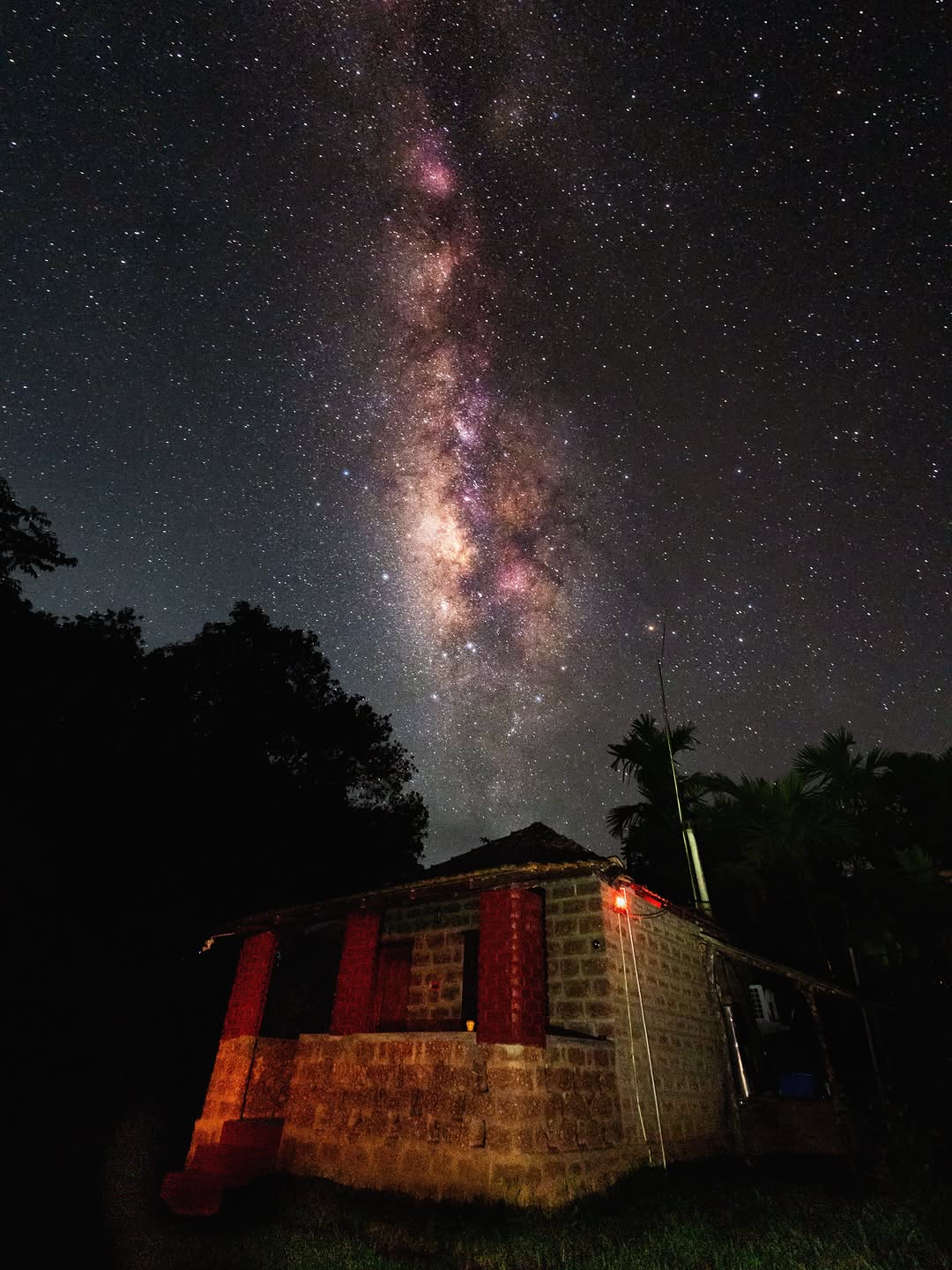 The Milky Way rising over a small brick hut under dark skies at Sirsi, Karnataka